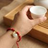 สร้อยข้อมือเชือกแดง ด้ายแดงมงคล + จี้หยกถุงทอง เสริมโชคลาภ เสริมด้านการเงิน ฮวงจุ้ย ปรับขนาดได้ สายมู